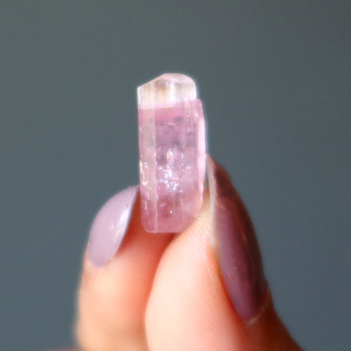 rough pink tourmaline gemstone in hand