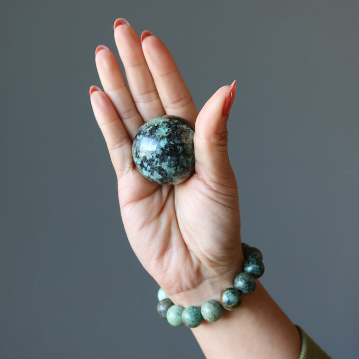 african turquoise sphere in hand