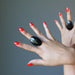 hands wearing large oval black agate rings