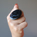 hand wearing large oval black agate ring