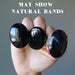 hand holding three black agate oval rings showing natural white bands