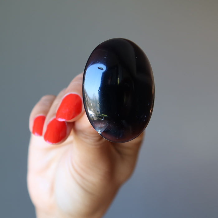 hand holding large oval black agate ring