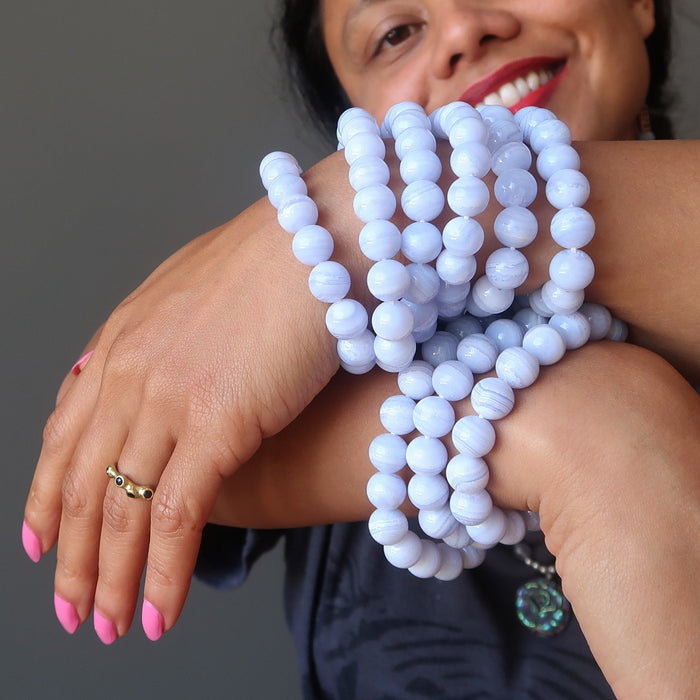 sheila of satin crystals wearing many blue lace agate round beaded stretch bracelets