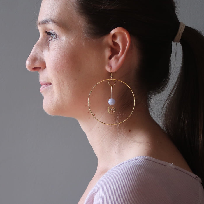 woman wearing blue lace agate gold hoop earrings