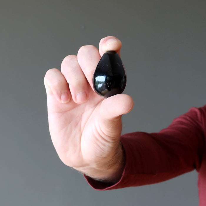 hand holding black agate egg