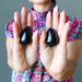 hand holding black agate eggs