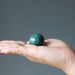 moss agate sphere in hand