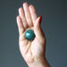 moss agate sphere in hand