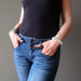 female model with both hands in jean pockets wearing amazonite bracelets