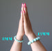 hands in prayer wearing a 8mm and a 13mm amazonite bracelet