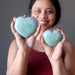 sheila of satin crystals holding two light Shiny Stone green Amazonite Hearts one on each hand 