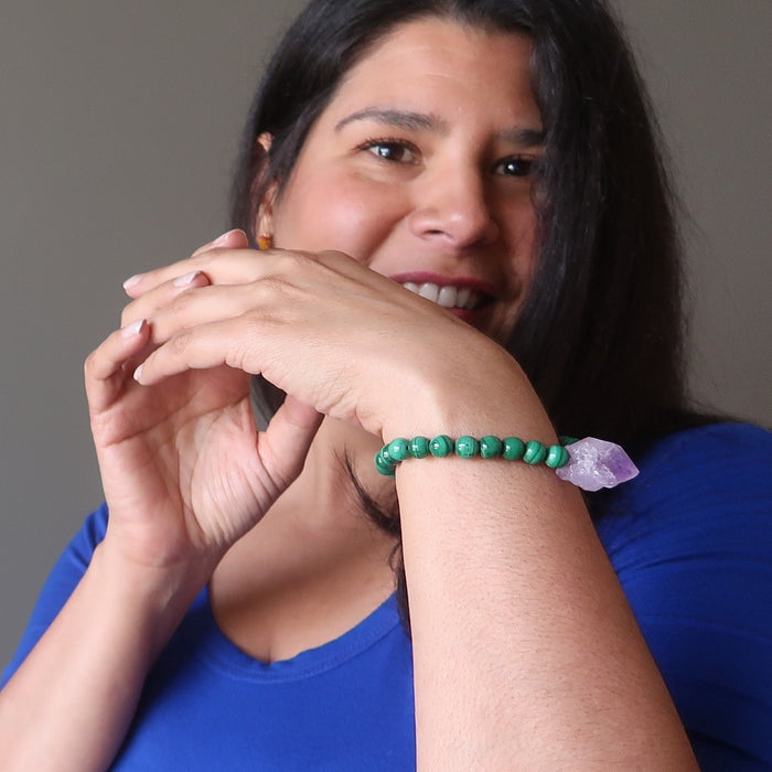A model smiles while wearing her malachite amethyst gemstone bracelet