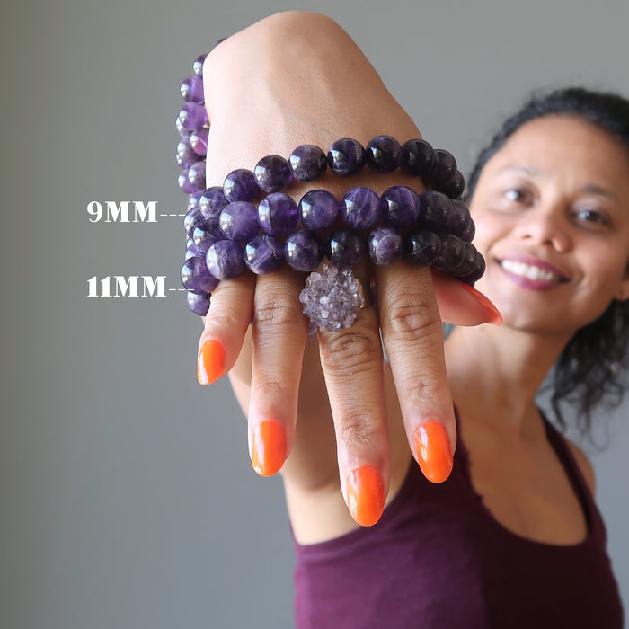 woman wearing dark amethyst bracelets and ring
