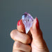 hand holding raw amethyst crystal point