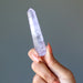 fingers holding 3.1 x 0.7 Inches  Clear Violet Purple Amethyst Crystal Point faceted wand 