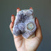 hand holding amethyst cluster geode