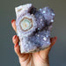 hand holding amethyst cluster geode
