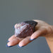 hand holding raw super 7 amethyst crystal point