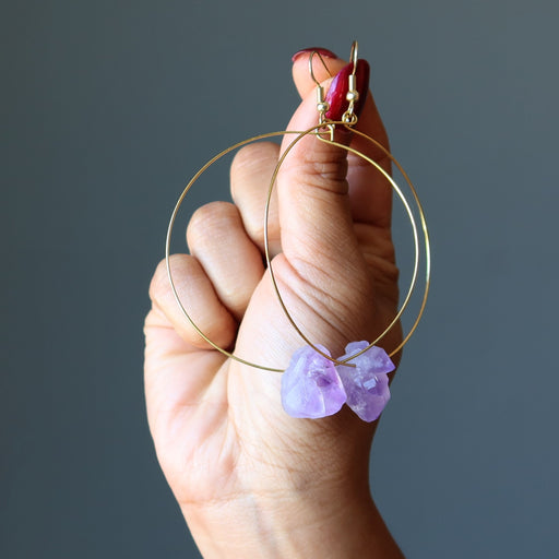 model hand holding 3.5 x 2.4 inches Raw Purple Amethyst Point Gold Hoop Earrings 