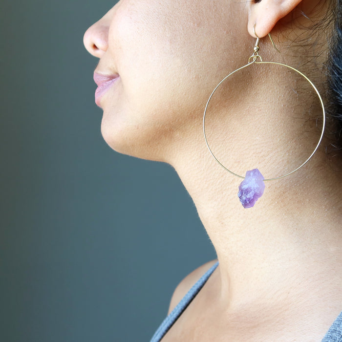 showing left side of sheila of satin crystals wearing 3.5 x 2.4 inches Raw Purple Amethyst Point Gold Hoop Earrings 
