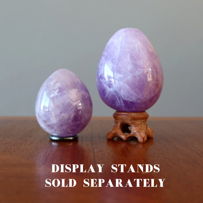 two different sizes Amethyst eggs are on the stands