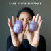 Sheila is holding an Amethyst egg on each hand