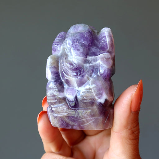 Model holding Amethyst purple Ganesh Elephant God 