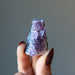 hand holding amethyst geode cluster