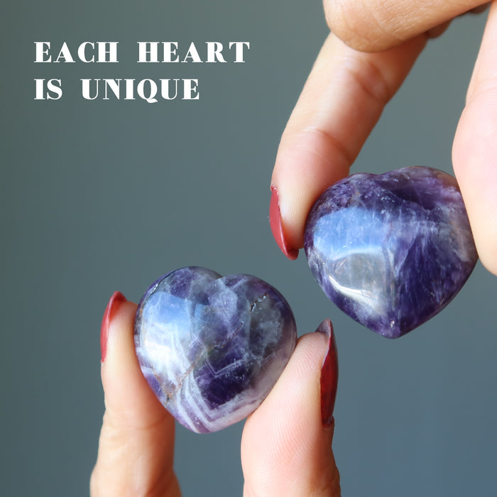hands holding purple amethyst heart set