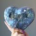 hand holding sparkling purple amethyst geode heart cluster showing back