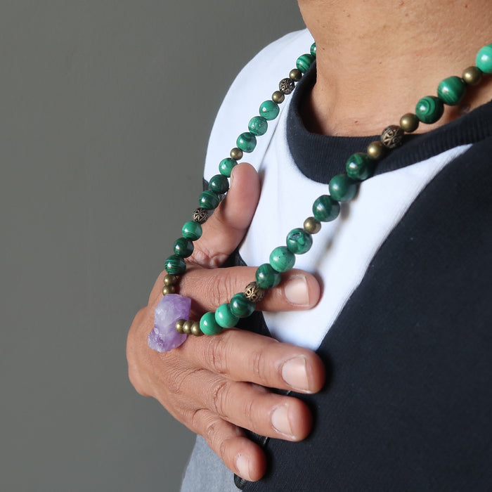 a male model The necklace made of raw purple Amethyst point  banded green Malachite and metal accent beads secured with a large lobster clasp