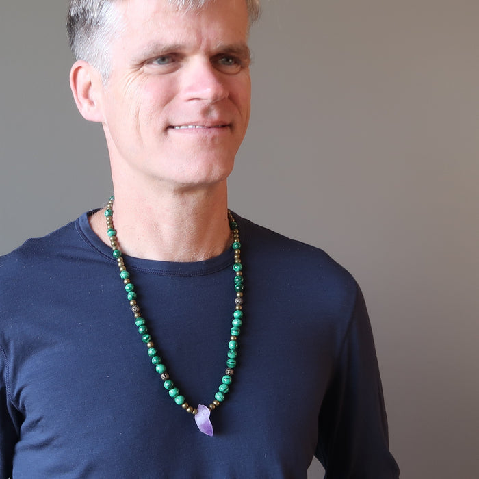 a male model The necklace made of raw purple Amethyst point  banded green Malachite and metal accent beads secured with a large lobster clasp