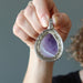 2.3 x 1.5 inches Teardrophand holding showing back side Purple Amethyst silver framed Pendant 