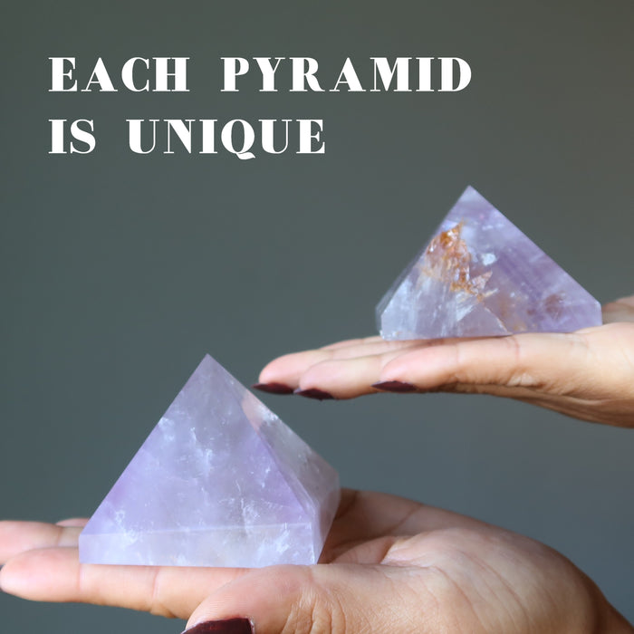 hand holding light purple amethyst pyramids to show each is unique