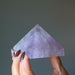 hand holding light purple amethyst pyramid