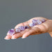 displaying 10-30mm Purple Raw Amethyst Double Terminated Set on model palm