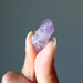 finger tips holding a Purple Raw Double Terminated Amethyst 