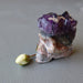 skull carved from an amethyst geode and rose bud