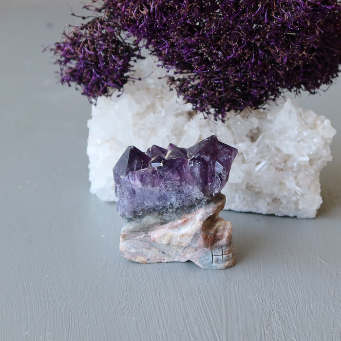skull carved from an amethyst geode with purple flowers