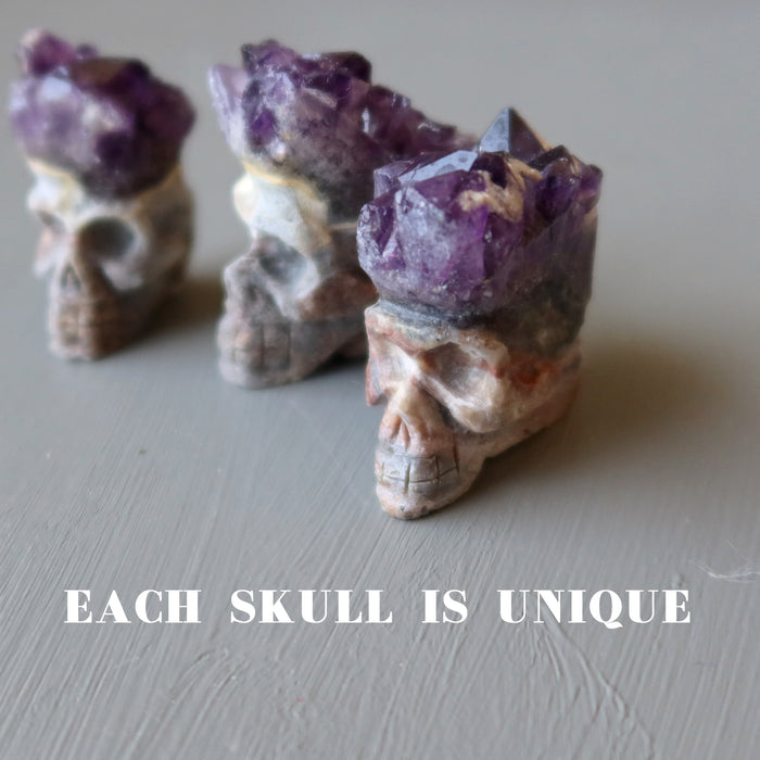 3 skull carved from an amethyst geode to show differences