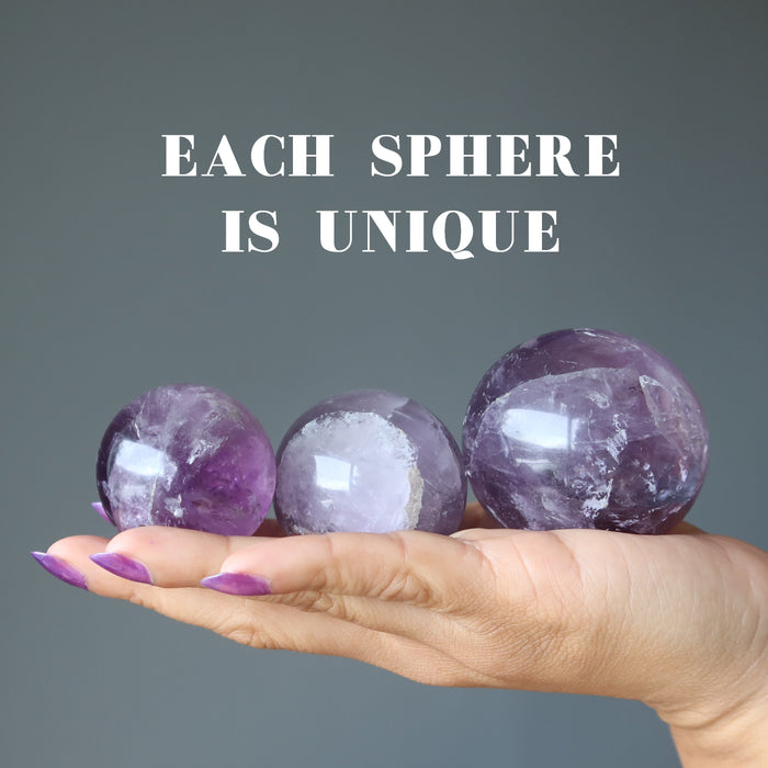 hand holding three amethyst spheres to show each is unique