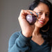 sheila of satin crystals holding an amethyst sphere