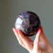 hand holding amethyst mineral mania sphere