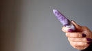 model holding 3.5-4 x 0.6 to 1 inches purple Amethyst Chevron crystal point tower Wand