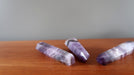 3  purple Amethyst Chevron crystal point tower Wands laying on the table