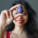 Sheila of Satin Crystals holding dark purple amethyst gemstone egg