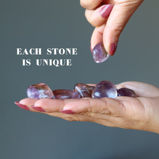 amethyst citrine tumbled stones on a palm