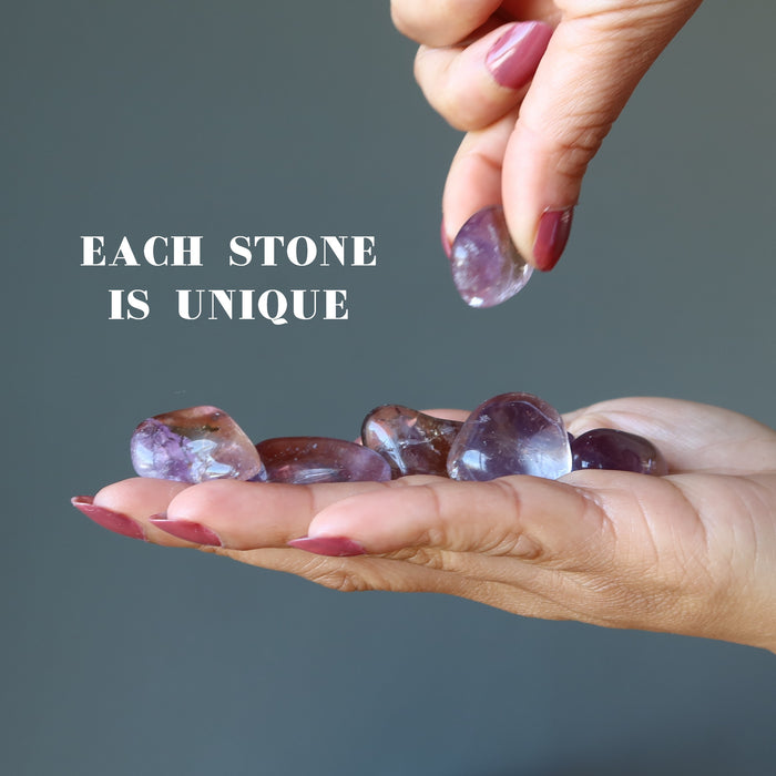 amethyst citrine tumbled stones on a palm
