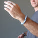 man wearing blue angelite bracelets