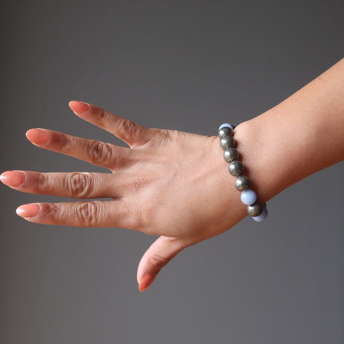 female hand modeling angelite pyrite stretch bracelet